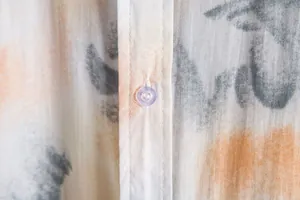 Close-up detail of casual floral shirt showing fabric texture and button fastening