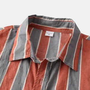 Close-up detail showing the collar and size M label of an orange striped Hawaiian beach shirt