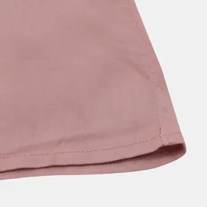 Close-up macro photography of a pink casual men's shirt hem showing neat double stitching