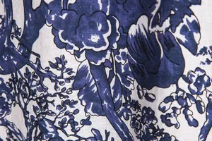 Detailed close-up showing the vintage blue floral print and fabric texture of the shirt