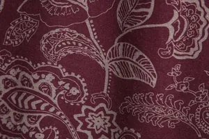 Macro detail of elegant burgundy paisley print on men's summer shirt fabric texture