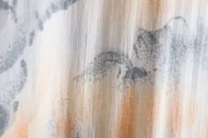 Detailed macro view of breathable cotton-linen fabric with abstract floral print