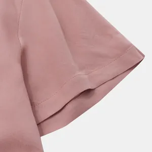 Close-up detail of a men's short sleeve pink shirt sleeve showing fabric texture.
