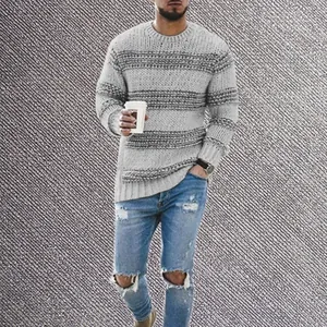 Detailed view of men's chunky knit crew neck sweater with grey and charcoal stripes