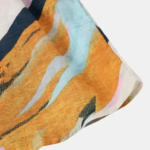 Close-up of breathable cotton-linen fabric with vibrant abstract print on Hawaiian shirt
