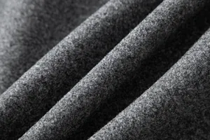 Macro view of the high-quality grey wool fabric texture for men's winter overcoat.