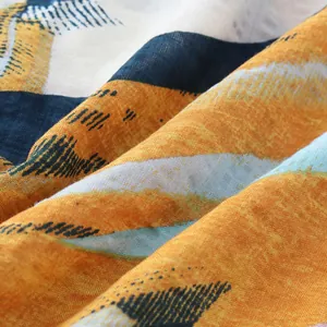 Close-up texture of Hawaiian style beach shirt fabric with vibrant orange and blue print.