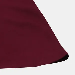 Close-up of burgundy men's shirt fabric showing neat and precise hem stitching detail.