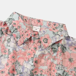 Dettaglio del colletto e dell'etichetta della taglia di una camicia floreale da uomo