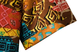 Close-up of ethnic tribal print fabric and sleeve cuff stitching on men's linen shirt