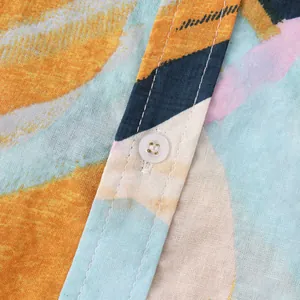 Close-up of lightweight fabric and abstract print on Hawaiian beach shirt.