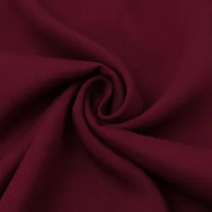 Close-up of burgundy twill fabric showing texture and soft drape for men's casual shirts.