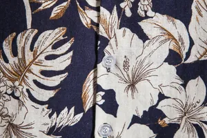 High-resolution macro detail of floral print and fabric on men's vintage Hawaiian shirt