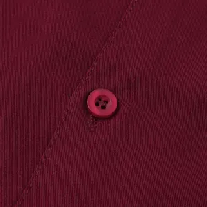 Close-up of burgundy men's shirt showing fine fabric texture and button detail