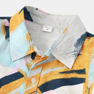 Detail view of a men's Hawaiian shirt collar with colorful brushstroke print and size label.