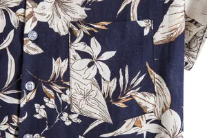 Detailed macro view showing the pocket and buttons of a vintage Hawaiian floral print shirt