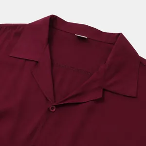 Detailed close-up of a burgundy men's casual shirt showing the collar and fabric texture