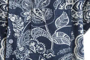 Close-up detail of men's blue paisley print short-sleeve shirt with chest pocket