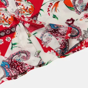 Detailed macro view showing the side slit and vibrant paisley print on a men's shirt