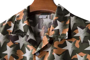 Close-up of men's Hawaiian shirt collar with camouflage star print and size label