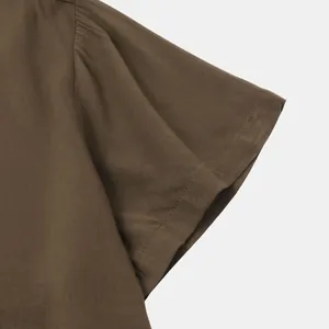 Close-up detail of the sleeve on a brown casual short-sleeve shirt for men