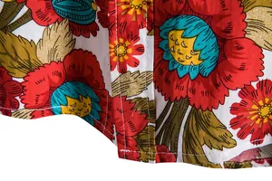 Macro detail view of men's casual floral shirt showing fabric texture and stitching