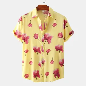 Close-up of vibrant yellow men's floral shirt with intricate pink flower print patterns