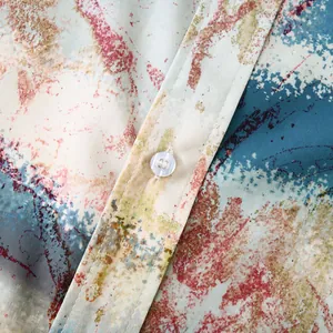 Gros plan détaillé du tissu imprimé floral hawaïen et du bouton d'une chemise homme.