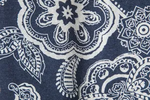 Close-up detail of navy blue and white paisley printed fabric for men's casual shirt