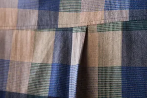 Close-up of breathable cotton linen plaid fabric and back pleat detail on shirt