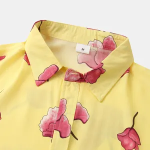 Detailed view of the collar and size M label on a yellow floral print men's shirt