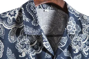 Close-up of blue paisley print and texture on men's short sleeve shirt collar.