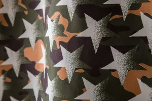 Close-up of camouflage and white star pattern on Hawaiian short sleeve shirt fabric