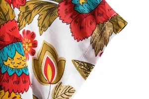 Close-up detail of vibrant floral print and stitching on men's summer casual shirt