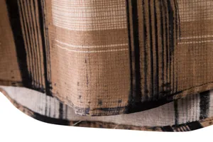 Close-up of brown plaid linen shirt hem showing detailed fabric texture and stitching