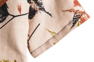 Close-up detail of retro floral leaf print and linen fabric on men's short sleeve shirt