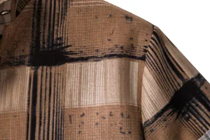 Close-up detail of men's casual cotton linen shirt with brown abstract grid pattern texture