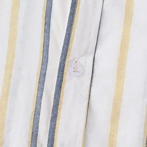 Macro detail of men's striped beach shirt showing fabric texture and white button
