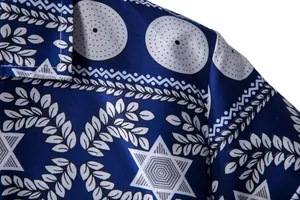 Detailed close-up view of ethnic geometric patterns on blue short sleeve men shirt