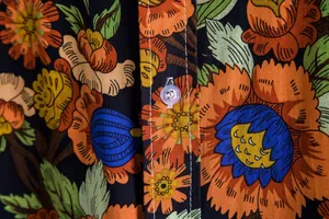 Close-up detail of vintage floral print pattern on casual short sleeve shirt fabric