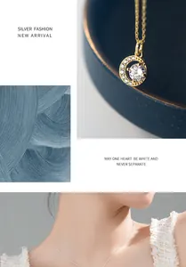 Close-up detail of an elegant gold crescent moon necklace with a sparkling round diamond