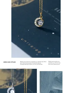 Elegant gold-plated round pendant necklace with sparkling cubic zirconia on blue background