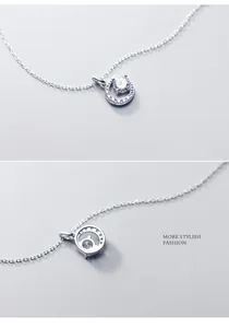 Close-up detail of a minimalist circular pendant necklace with a brilliant center stone