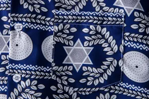 Detailed macro view of men's navy Hawaiian shirt with white ethnic star pattern.