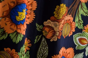 Macro detail of vibrant floral pattern on men's casual short-sleeve shirt fabric