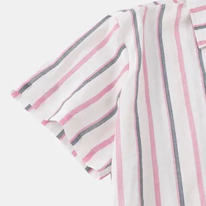 Macro detail showing the fabric and pink/blue stripes of a men's Hawaiian beach shirt