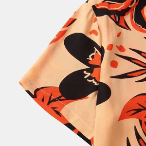 Detail of short sleeve cuff on men's floral print Hawaiian shirt with tropical pattern.