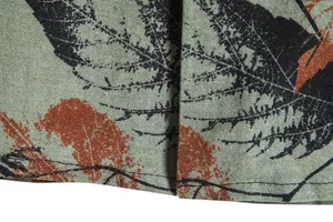 Macro detail of vintage floral leaf print on textured linen-blend men's shirt fabric