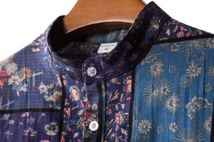 Macro view showing the collar detail and floral pattern of a men's casual linen shirt.
