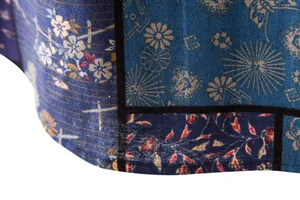 Detailed macro view of blue patchwork fabric with floral patterns on men's linen shirt
